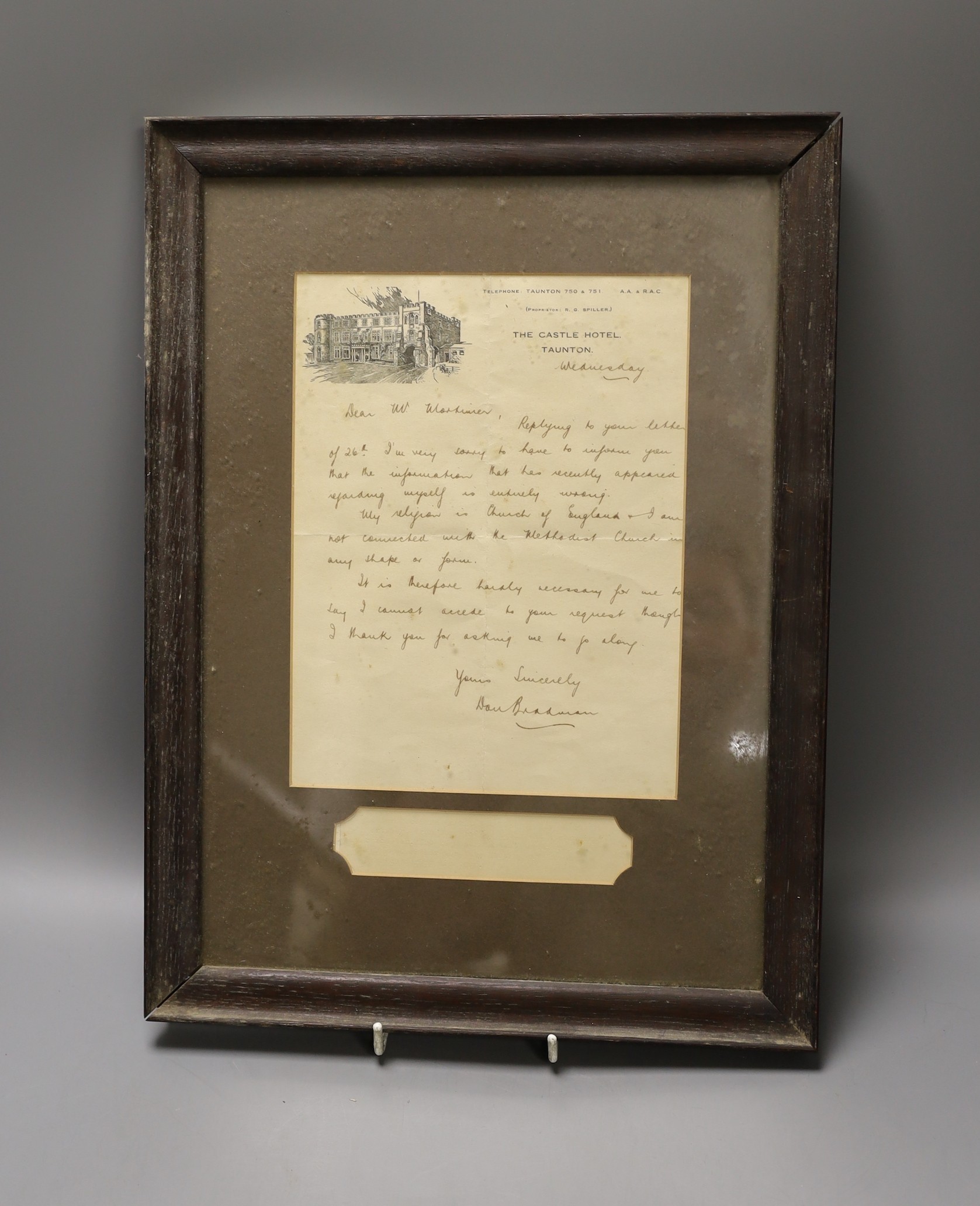 A signed letter written by Sir Don Bradman regarding his religion, framed